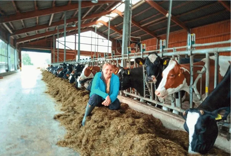 Katharina Heinert in front of cows