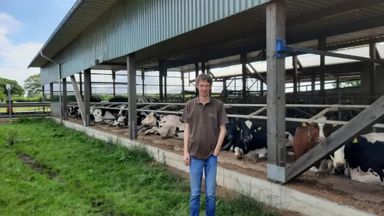 farmer in front of a barn